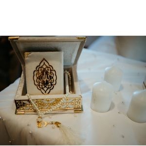 Gold and white Quran with prayer bead and case